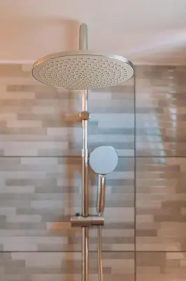a lamp with a table and a stool under it at Alexander Home in Vravrona