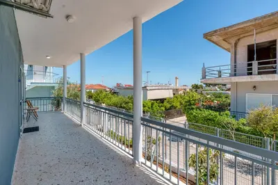 an apartment balcony with a view of the ocean at Alexander Home in Vravrona