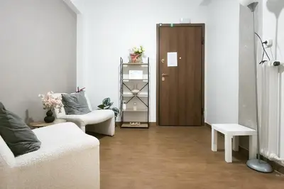 a living room with a door and a couch and a table at Velora Apartments in Athens