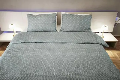 a bedroom with a large bed with two pillows at Velora Apartments in Athens