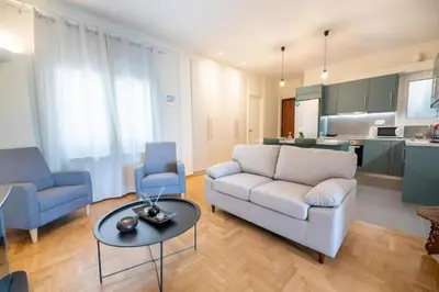 a living room with a couch and a table at 5th floor Apt with Acropolis view in Pangrati in Athens