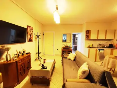 a living room with a couch and a flat screen tv at Cozy & Connected in Athens