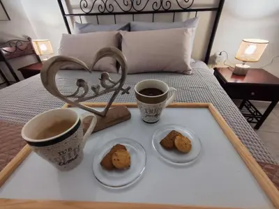 two cups of coffee and cookies on a tray on a bed at Cozy & Connected in Athens