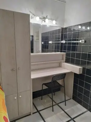 a bathroom with a sink and a chair and a mirror at Cozy little room in Athens