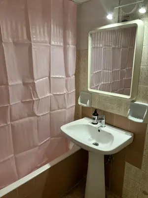 a bathroom with a sink and a pink shower curtain at Cozy little room in Athens