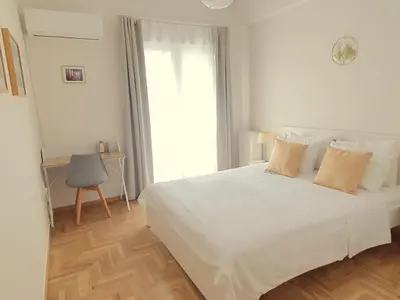 a bedroom with a white bed and a window at Vintage Chic in Athens