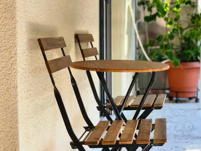 a table and a chair sitting next to a building at Vintage Chic in Athens