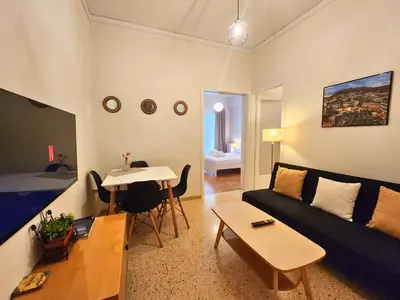 a living room with a couch and a table at Vintage Chic in Athens