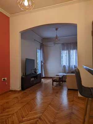 an empty living room with a couch and a tv at Ασφαλές και σύγχρονο διαμέρισμα in Athens