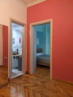 a room with red walls and a bedroom with a bed at Ασφαλές και σύγχρονο διαμέρισμα in Athens