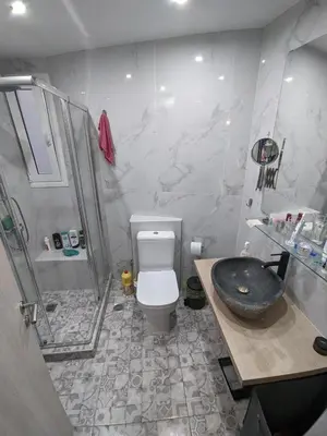 a bathroom with a shower and a toilet and a sink at Ασφαλές και σύγχρονο διαμέρισμα in Athens