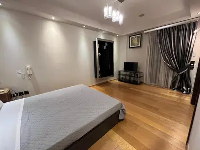 a bedroom with a bed and a television in it at MARGARITAS' SUITES viktoria square in Athens