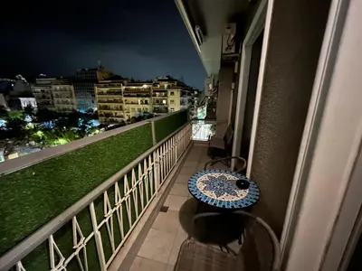 a balcony of a building with a table on it at MARGARITAS' SUITES viktoria square in Athens