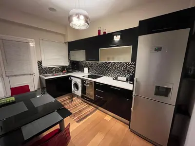a kitchen with a stainless steel refrigerator and a sink at MARGARITAS' SUITES viktoria square in Athens
