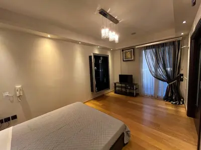 a bedroom with a bed and a television in it at MARGARITAS' SUITES viktoria square in Athens