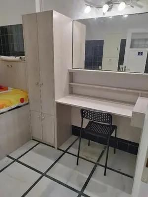 a bathroom with a chair and a mirror at Cozy little room in Athens
