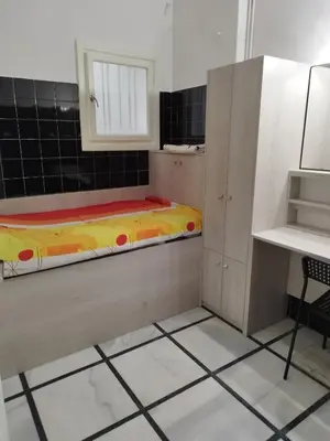 a small room with a bed and a cabinet at Cozy little room in Athens