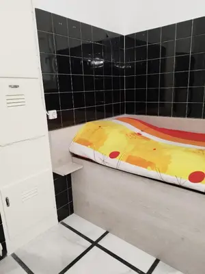 a bed sitting on a counter in a bathroom at Cozy little room in Athens