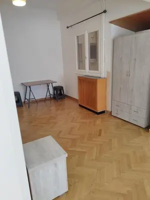 an empty room with a table and a wooden floor at Triple room in Athens