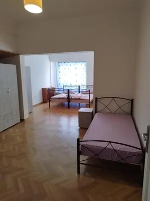 a bedroom with two beds in a room at Triple room in Athens