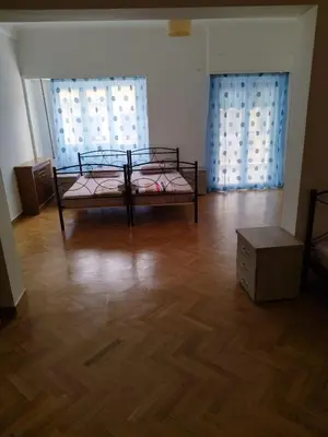 a room with a bed and two windows at Triple room in Athens