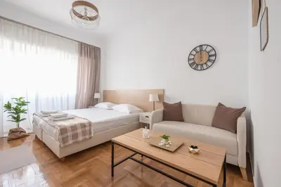 a living room with a bed and a couch at Ble Elia Estia Suite in Athens