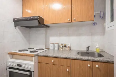 a small kitchen with a stove and a sink at Ble Elia Estia Suite in Athens