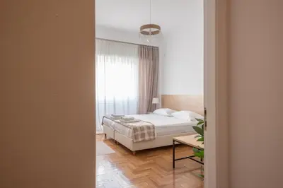 a bedroom with a bed and a window at Ble Elia Estia Suite in Athens