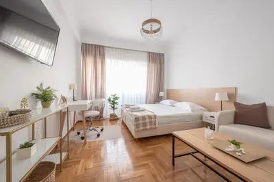 a bedroom with a bed and a living room at Ble Elia Estia Suite in Athens
