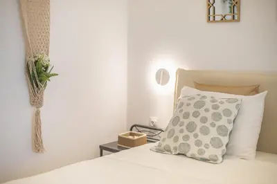 a bedroom with a bed with a pillow and a vase at Ble Elia Parthenon Suite in Athens