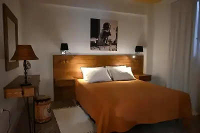 a bedroom with a large bed with a wooden headboard at Athenian Stay 302 Apartment in Athens