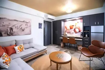 a living room with a couch and a dining room at Athenian Stay 302 Apartment in Athens