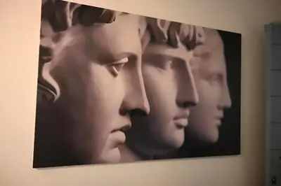 a painting of a group of heads on a wall at Athenian Stay 302 Apartment in Athens
