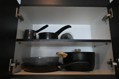 a kitchen with a sink and pots and pans on a shelf at Athenian Stay 303 Apartment in Athens