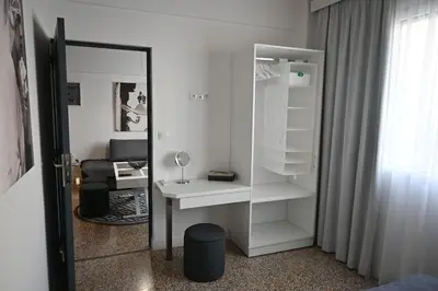 a white room with a desk and a mirror at Athenian Stay 303 Apartment in Athens