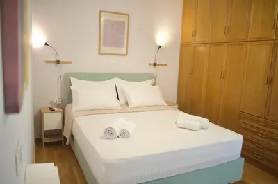 a bedroom with a bed with two towels on it at Cozy & Luxurious 70m2 apartment in Athens