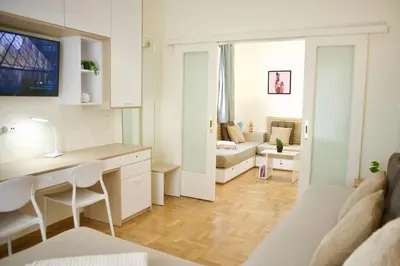 a kitchen and living room with a desk and a couch at Cozy & Luxurious 70m2 apartment in Athens