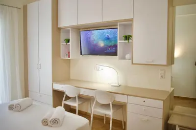 a kitchen with a desk with two chairs and a tv at Cozy & Luxurious 70m2 apartment in Athens