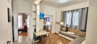 a living room with a couch and a table at Cozy & Luxurious 70m2 apartment in Athens