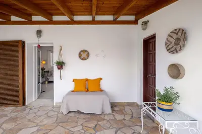 a bedroom with a bed with orange pillows on it at Mira Seaside Residence in Kalívia Thorikoú