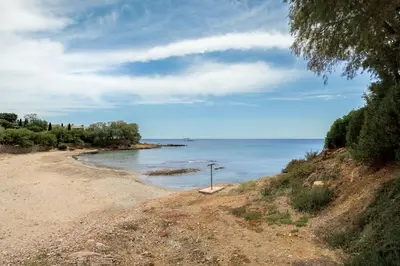 a sandy beach with the ocean in the background at Mira Seaside Residence in Kalívia Thorikoú