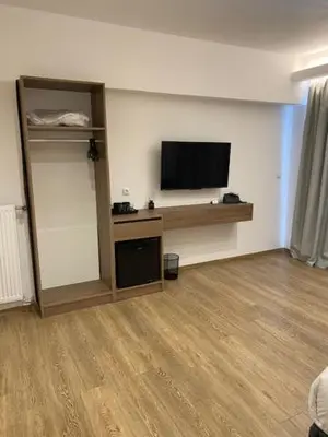 a room with a flat screen tv on a wall at Real City Suites Lekka in Athens