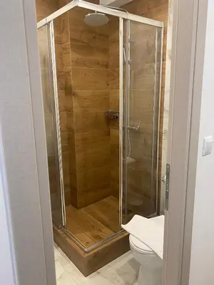 a glass shower in a bathroom with a toilet at Real City Suites Lekka in Athens