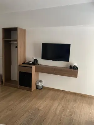a living room with a flat screen tv on a wall at Real City Suites Lekka in Athens