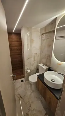 a bathroom with a white toilet and a sink at Real City Suites Lekka in Athens
