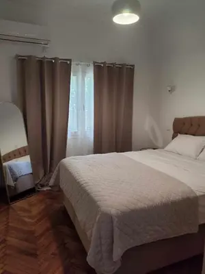 a bedroom with a large bed and a window at Athenian Stay Chara's Apartment in Athens
