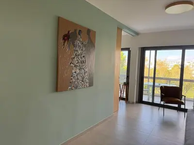 a living room with a painting on the wall at Nomadic life-Elegant Apartment by Athens Riviera in Athens