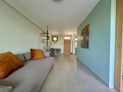 a living room with a couch and a hallway at Nomadic life-Elegant Apartment by Athens Riviera in Athens