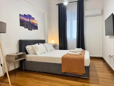 a bedroom with a bed and a television in it at Athenian Stay Kolonaki Apartment in Athens