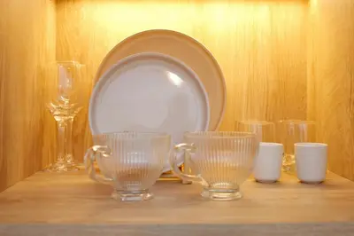a table with glasses and a plate on a shelf at Blisséa in Piraeus